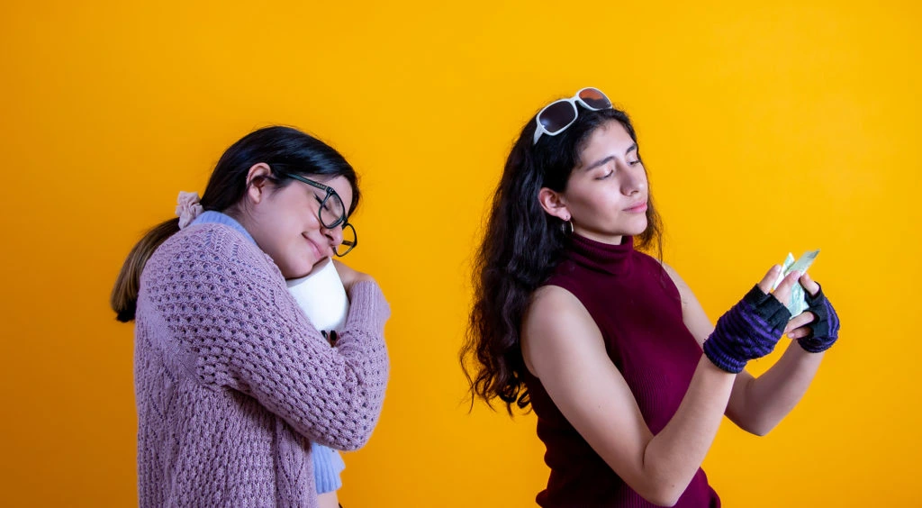 once woman hugging toilet paper and the other counting her money as an example of price gouging 