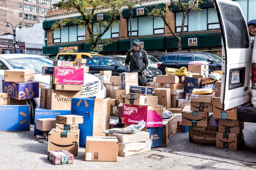 man delivering a lot amazon shipping parcels