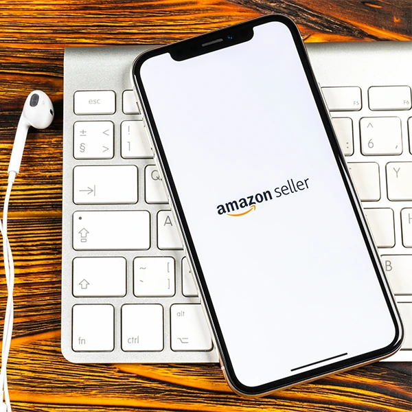 amazon seller app on a phone resting on a keyboard