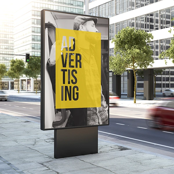 billboard on sidewalk with yellow 'advertising' poster