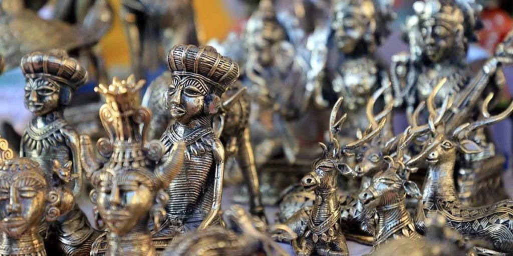 several traditional-style carved metal human and animal figures